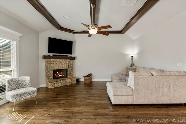 living room featuring lofted ceiling with beams, a stone fireplace, dark hardwood / wood-style floors, and ceiling fan