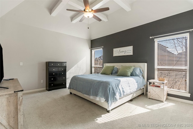 carpeted bedroom featuring multiple windows, ceiling fan, and beamed ceiling