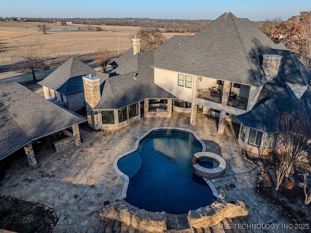 view of pool featuring an in ground hot tub, a patio area, and a fire pit