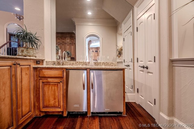 bar featuring crown molding, light stone countertops, dark wood-type flooring, and sink