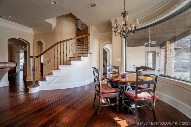 dining room featuring ceiling fan with notable chandelier, dark wood-type flooring, and ornamental molding