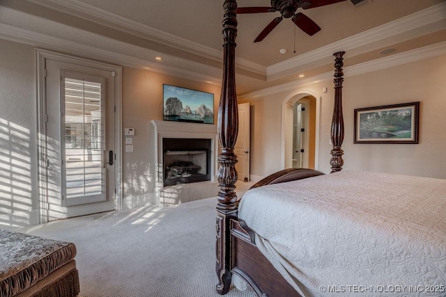 carpeted bedroom featuring a raised ceiling, ornamental molding, access to outside, and ceiling fan