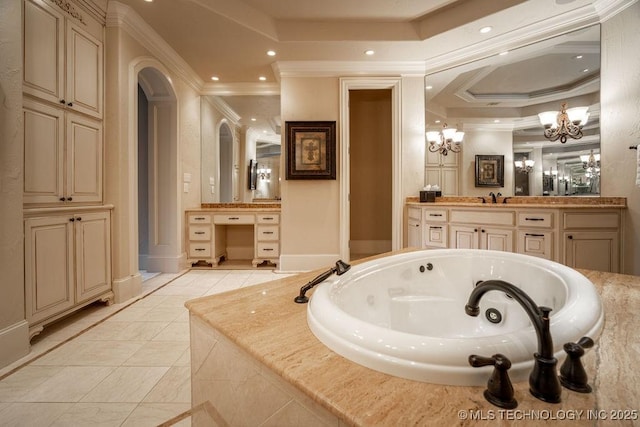 bathroom with crown molding, a relaxing tiled tub, vanity, a notable chandelier, and a raised ceiling