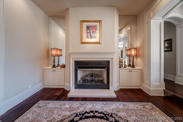 unfurnished living room with dark hardwood / wood-style flooring