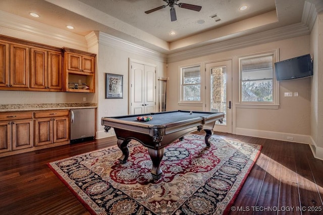 rec room featuring pool table, dark hardwood / wood-style flooring, and a tray ceiling