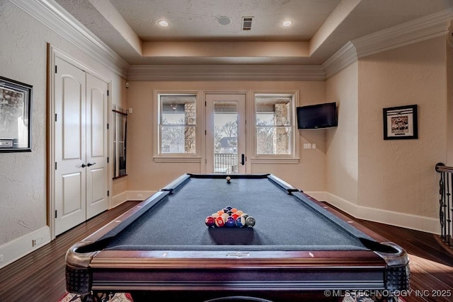 recreation room with billiards, a tray ceiling, wood-type flooring, and ornamental molding