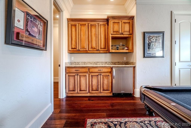 interior space featuring billiards, dark wood-type flooring, ornamental molding, and stainless steel refrigerator