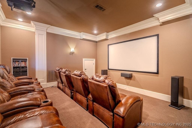 carpeted cinema room with crown molding and ornate columns