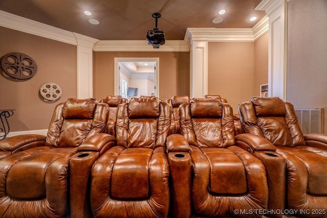 home theater room with decorative columns and crown molding