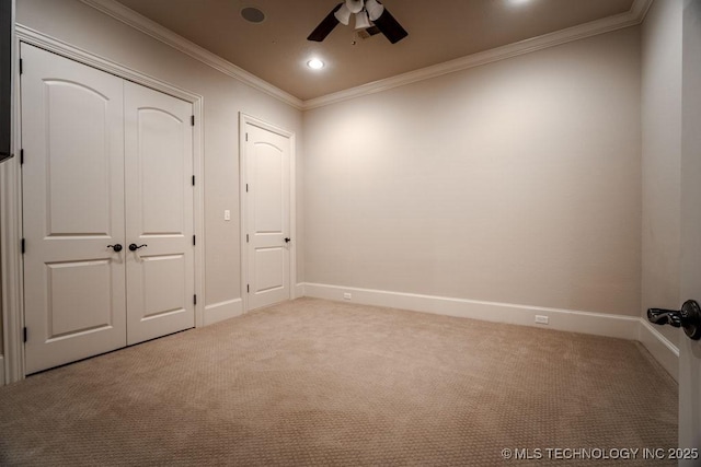 unfurnished bedroom featuring crown molding, light colored carpet, a closet, and ceiling fan