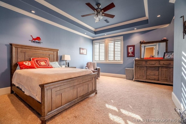 bedroom featuring crown molding, ceiling fan, a tray ceiling, and light colored carpet