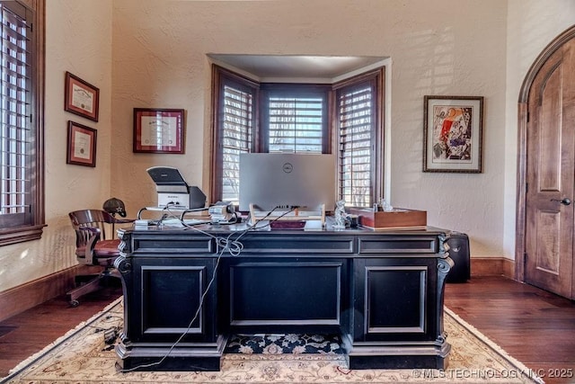 home office with crown molding and dark hardwood / wood-style floors