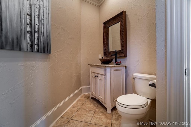 bathroom with ornamental molding, tile patterned floors, toilet, and vanity