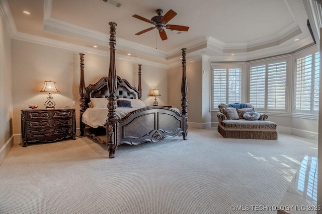 carpeted bedroom featuring crown molding, ceiling fan, and a tray ceiling