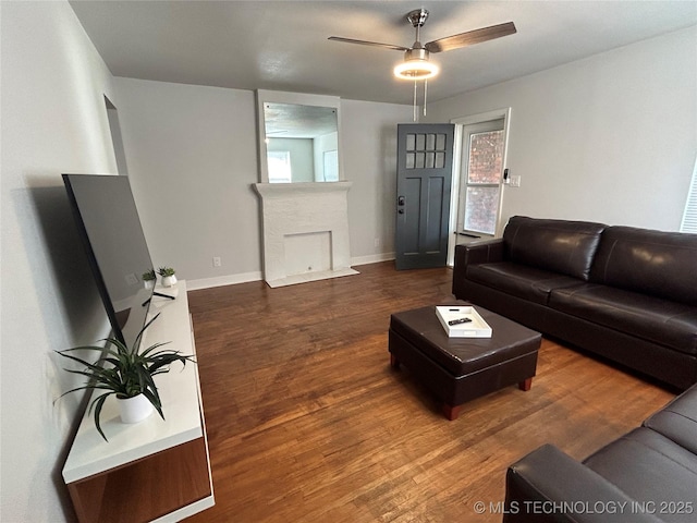 living room with ceiling fan and dark hardwood / wood-style floors