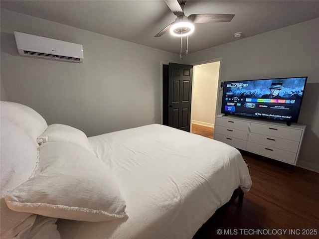 bedroom featuring dark hardwood / wood-style flooring, an AC wall unit, and ceiling fan