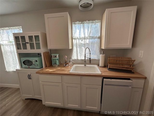 kitchen with white cabinetry, sink, white dishwasher, and plenty of natural light