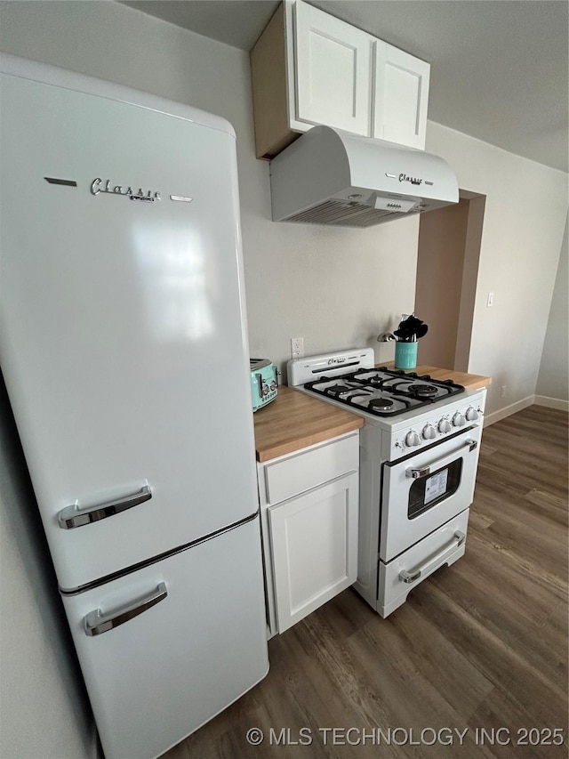 kitchen with dark hardwood / wood-style floors, white cabinets, and white appliances