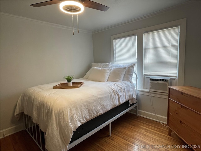 bedroom featuring crown molding, ceiling fan, and light hardwood / wood-style flooring