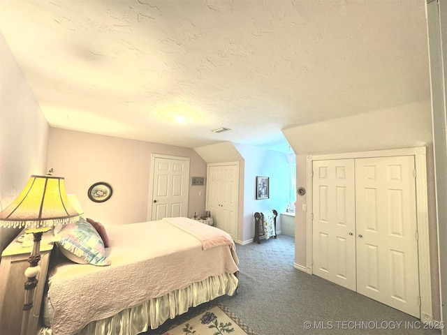 carpeted bedroom with lofted ceiling and a textured ceiling