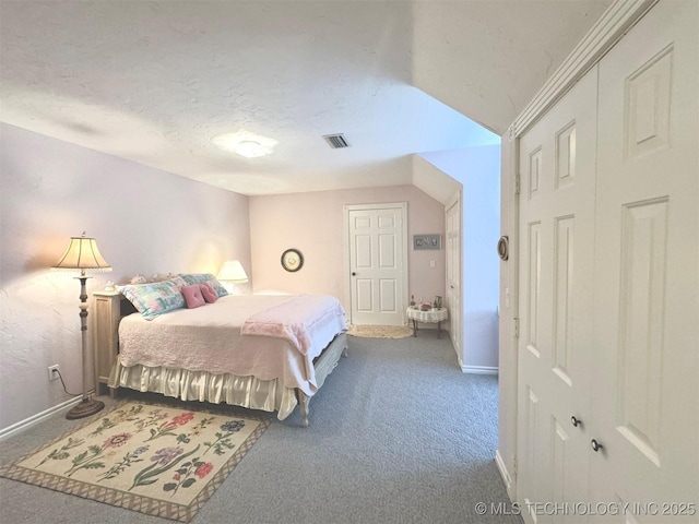 bedroom with carpet floors, a textured ceiling, and a closet