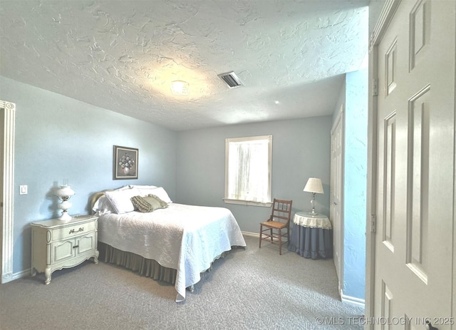 bedroom with light carpet and a textured ceiling