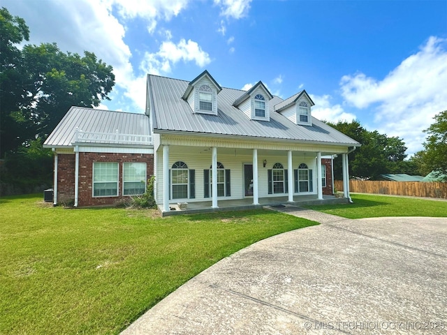 new england style home with a porch and a front yard