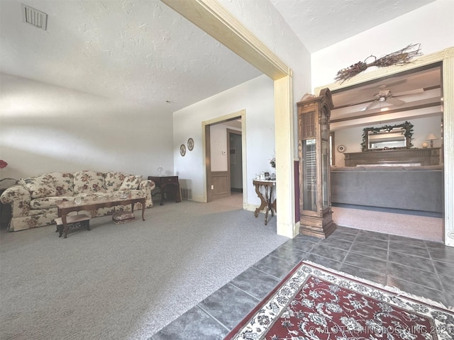 interior space with a textured ceiling and dark colored carpet