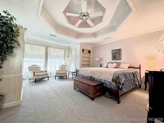 carpeted bedroom featuring crown molding, a raised ceiling, and ceiling fan