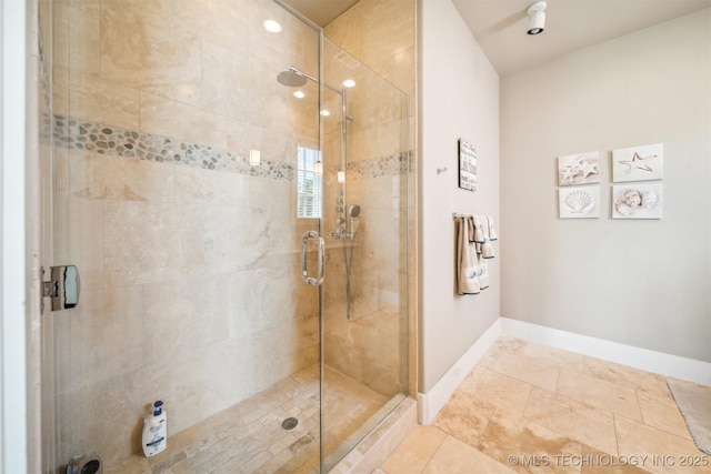 bathroom with a shower with door and tile patterned flooring