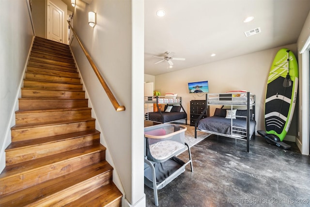 staircase with concrete flooring and ceiling fan