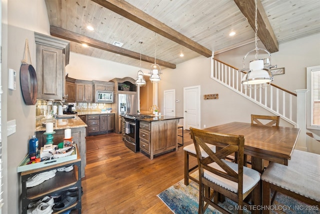 kitchen featuring appliances with stainless steel finishes, a center island, wooden ceiling, and beam ceiling