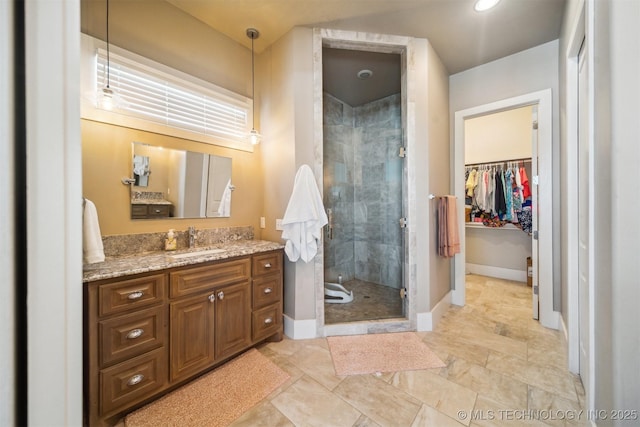 bathroom featuring vanity and a shower with door