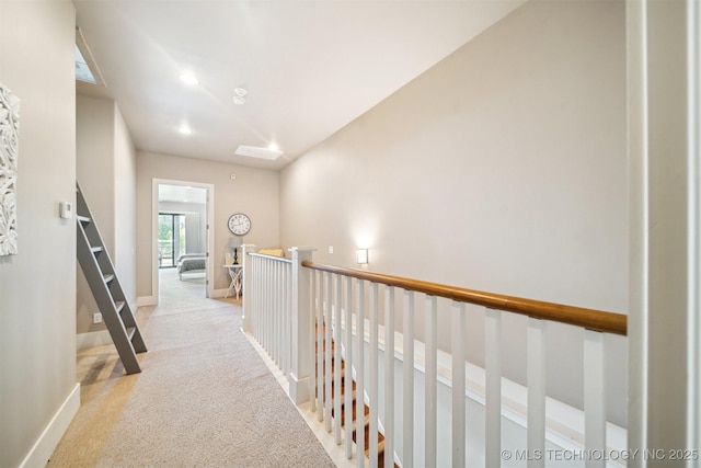 hallway featuring light carpet