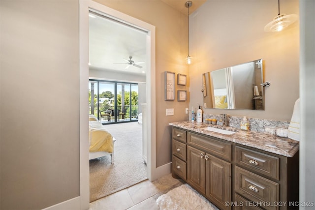 bathroom with tile patterned flooring, vanity, and ceiling fan