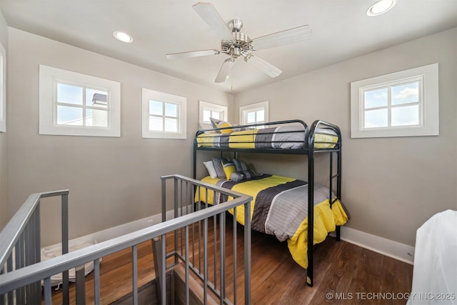 bedroom with dark hardwood / wood-style floors and ceiling fan