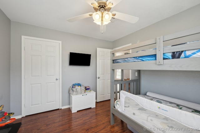 bedroom with ceiling fan and dark hardwood / wood-style floors