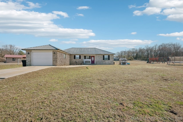 ranch-style home featuring a trampoline, a garage, and a front lawn