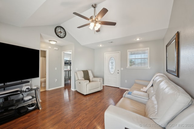 living room with ceiling fan, dark hardwood / wood-style floors, and vaulted ceiling