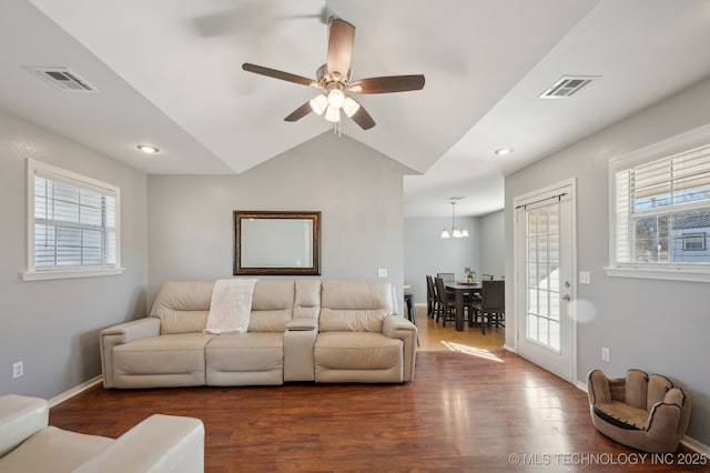 living room featuring dark wood-type flooring, ceiling fan, and vaulted ceiling