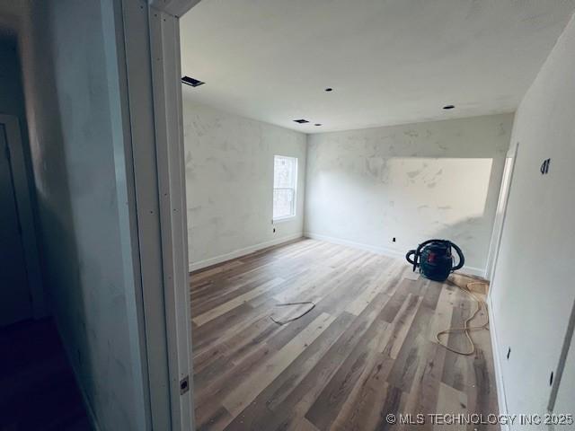 empty room with hardwood / wood-style flooring