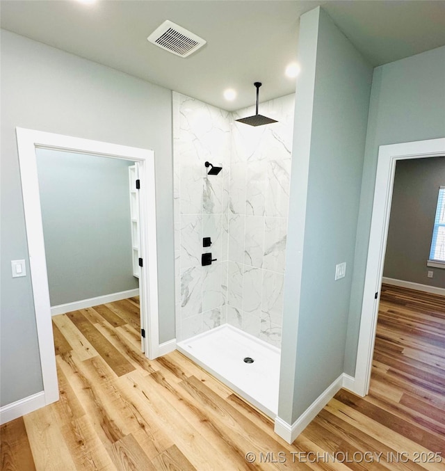 bathroom with visible vents, baseboards, and wood finished floors