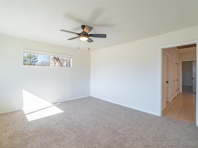 empty room featuring light carpet and ceiling fan