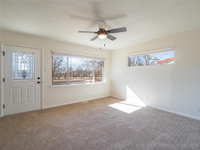 carpeted foyer featuring ceiling fan