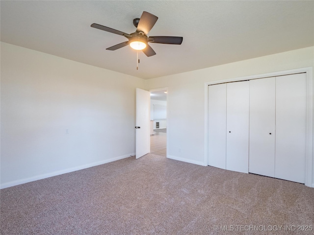 unfurnished bedroom with light carpet, ceiling fan, and a closet