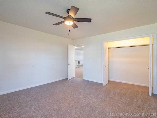 unfurnished bedroom featuring ceiling fan, light carpet, and a closet