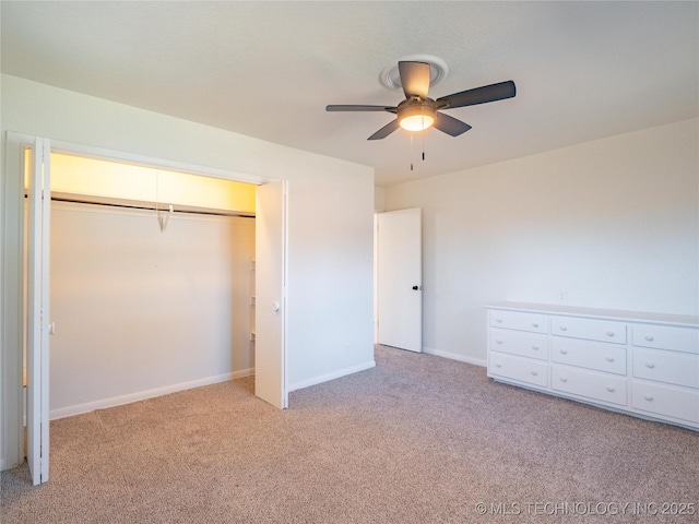 unfurnished bedroom with ceiling fan, light carpet, and a closet