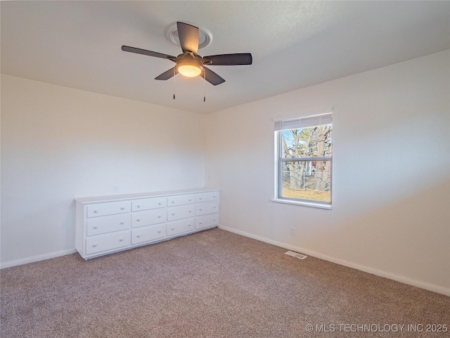 unfurnished bedroom featuring light carpet and ceiling fan