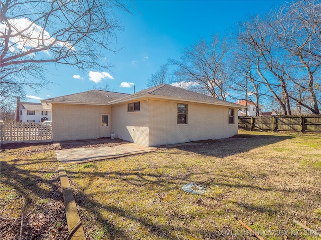 rear view of property with a yard