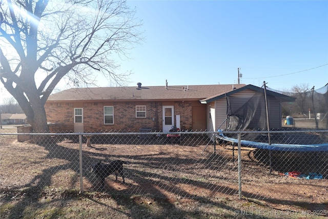 rear view of house with a trampoline